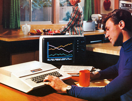 A man in a kitchen using an Apple II from a 1977 advertisement.